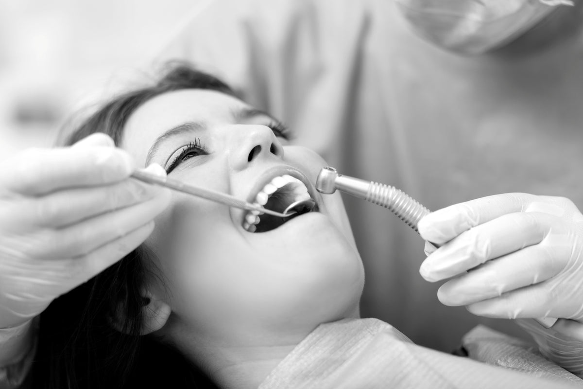 Dental professional with a denture wearer in a bright dental office